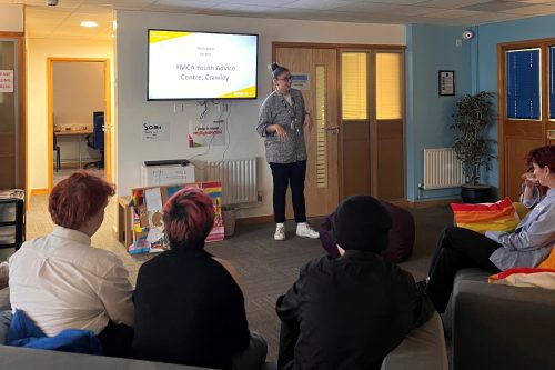 Eli Adie explaing LGBTQU+ haven to MP Henry Smith and group memebers