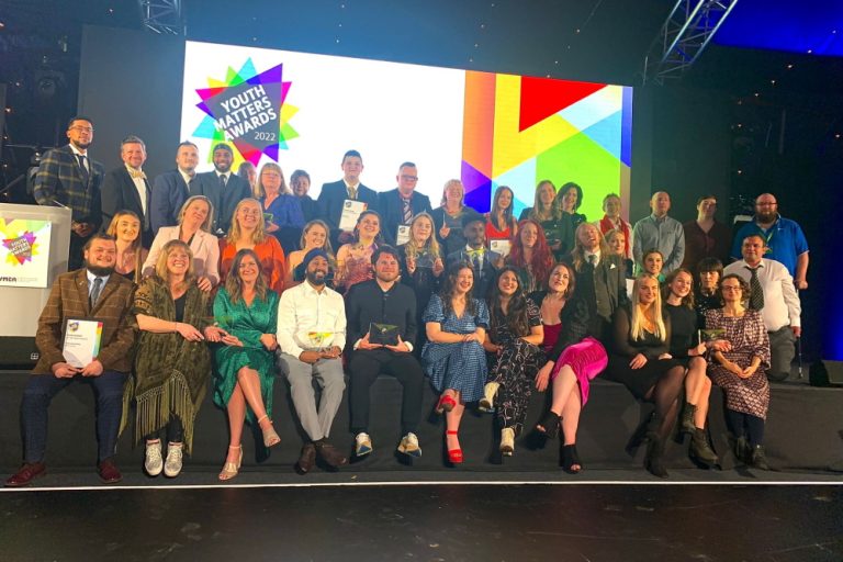 Youth Matters Awards 2022 finalists sat on stage with their awards