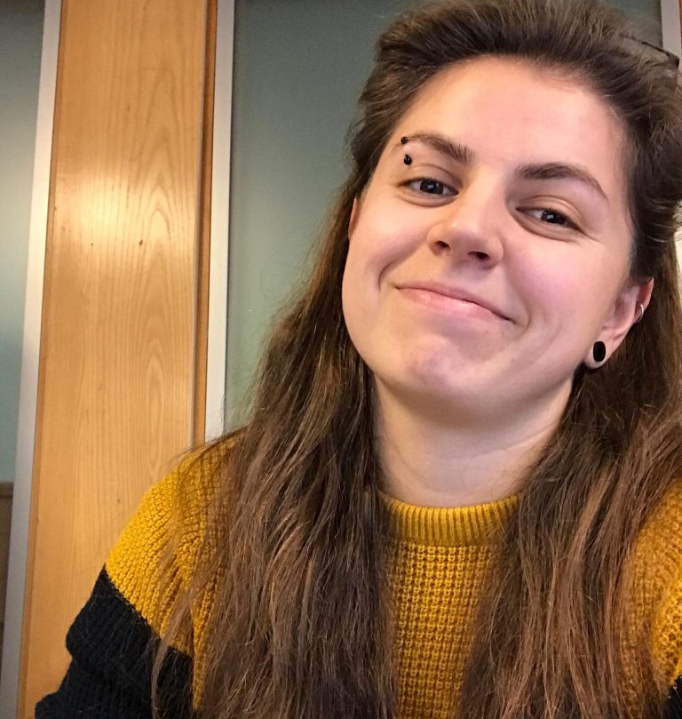 Picture of young woman smiling. She speaks about youth services