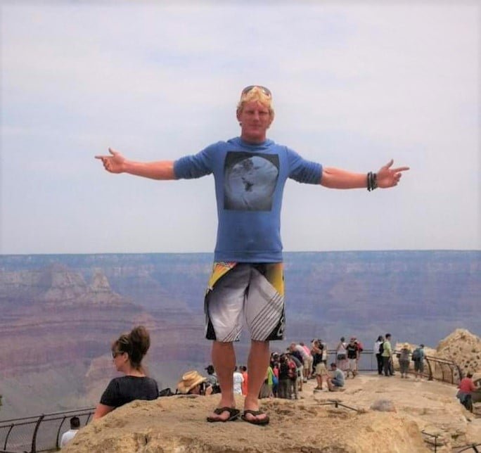 Man on a hill with outstretched arms He speaks about youth services