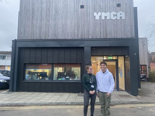 Randy stood outside a YMCA supported accommodation with his Project Worker