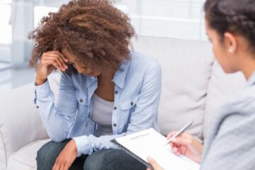 woman in therapy setting looking sad