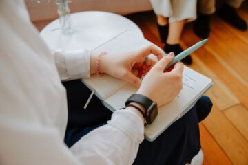 woman writing in book