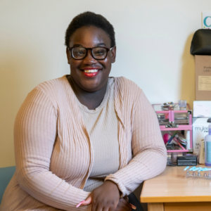 Mapalo, one of the young people that lived in our supported accomodation, smiling in her room