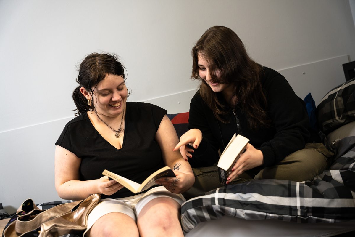 tenant satisfaction featured image. two girls sat on a bed reading together