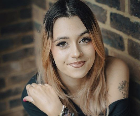 Young woman with brick wall background