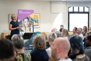 ceo ymca downslink group, emily brock, speaking at the event