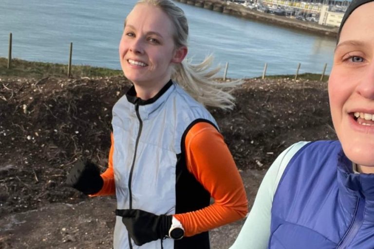 two women running along the seafront selfie