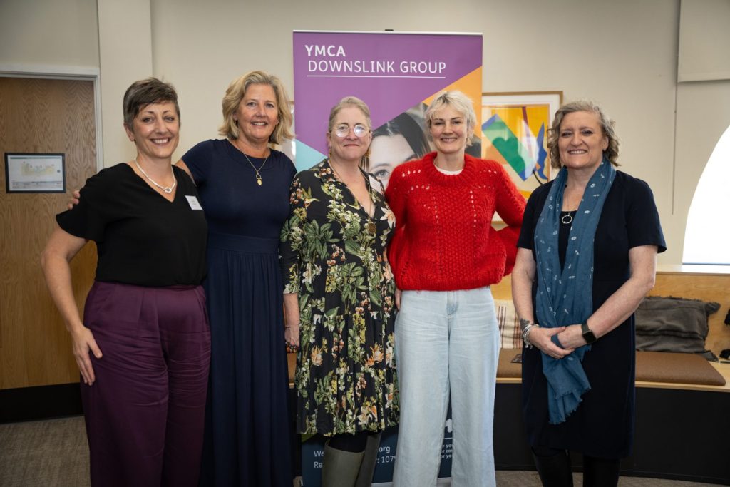 five women standing together and smiling at ymca downslink group event for world mental health day and world homelessness day