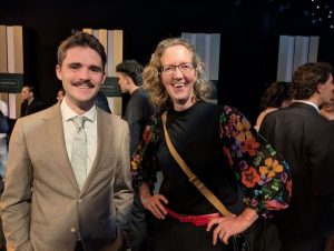 two people standing and smiling