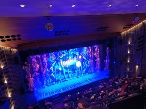 view of the Yvonne Arnaud stage, lit in blue, from high seats