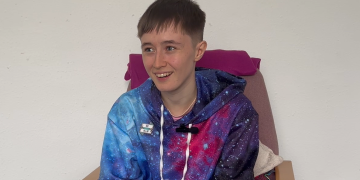 Vivian smiling, wearing a space patterned hoodie