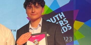 Randy at the Youth Matters Awards smiling holding his certificate