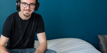 Daniel sat on his bed listening to music